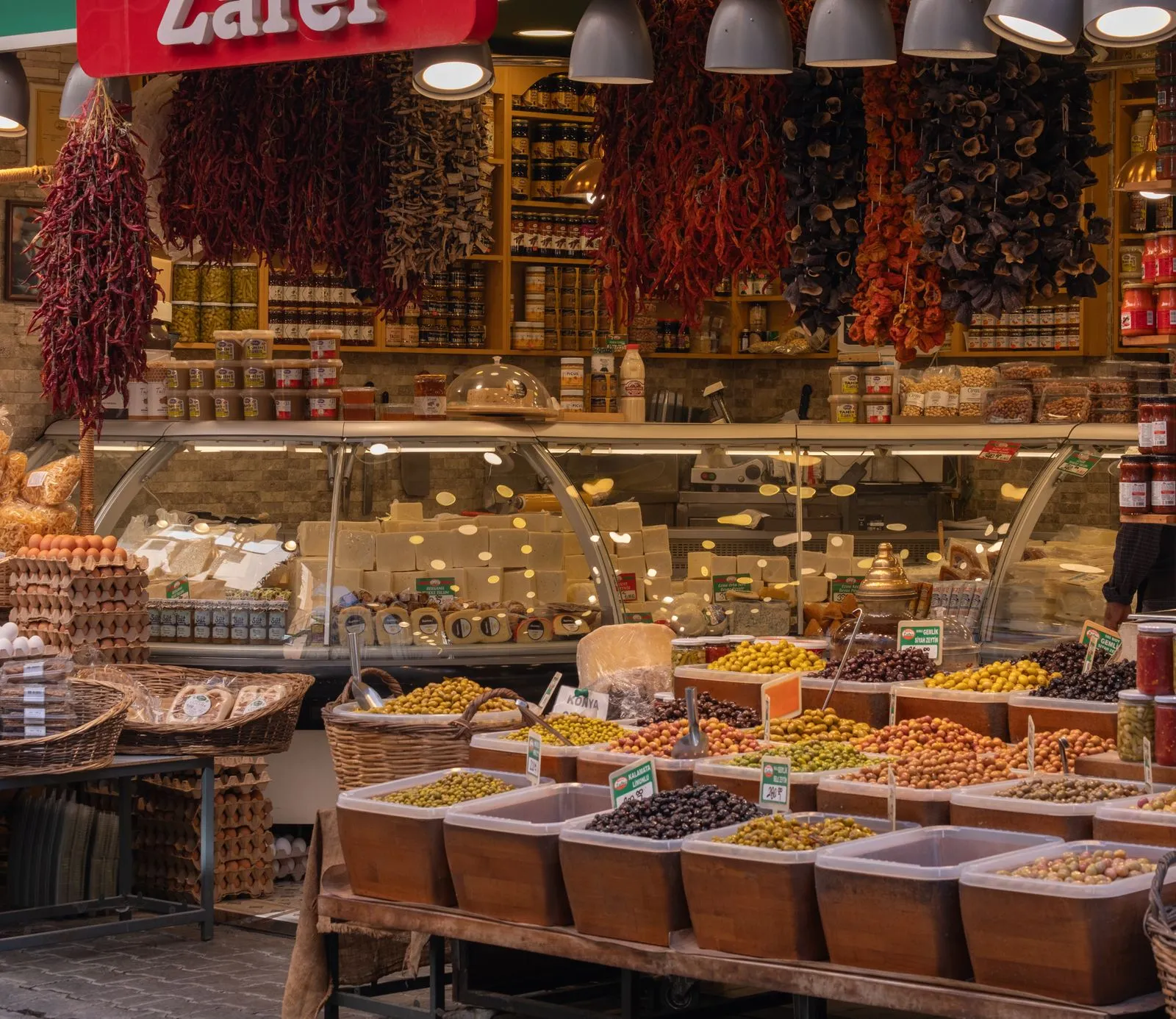 Vibrant olive display at a traditional market in İzmir, Türkiye, showcasing rich local produce.